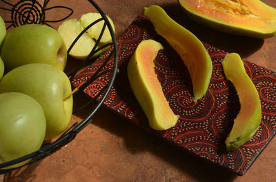 Still life with apple and papaya slices