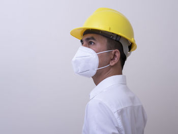 Portrait of man working against white background