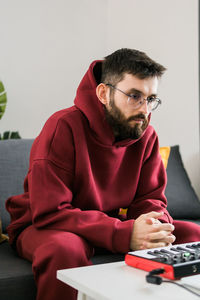 Young man using calculator