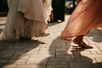Detail of bride and bridesmaid dancing at wedding party
