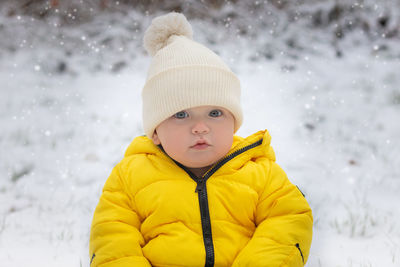 Portrait of boy standing on snow