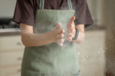 Midsection of man standing in puddle