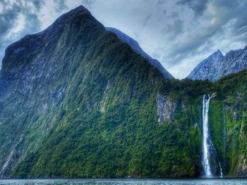 Scenic view of waterfall against sky