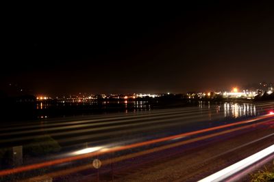 Illuminated city against sky at night