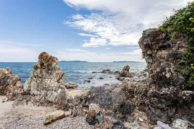 Rocks on beach against sky