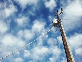 Low angle view of electricity pylon against sky