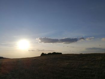 Scenic view of field against sky during sunset