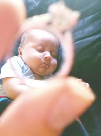Close-up of baby holding girl