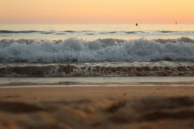 Scenic view of beach against sky during sunset