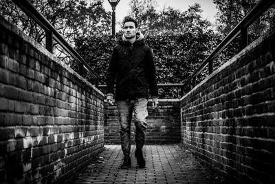 Full length of woman standing by railing