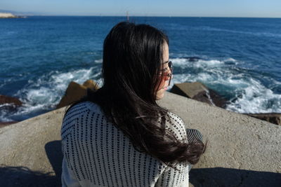 Rear view of woman looking at sea shore