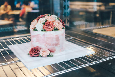 Close-up of roses in glass on table