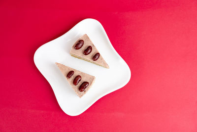 High angle view of heart shape on red cake