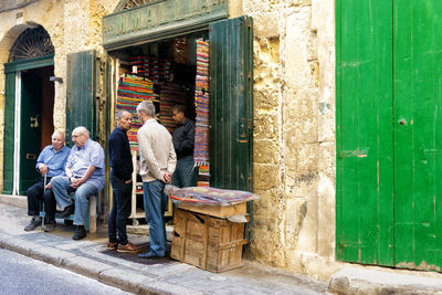 People sitting outside building