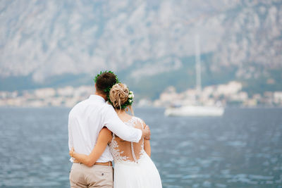 Rear view of couple embracing outdoors