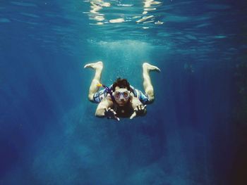 Portrait of mid adult man swimming in sea