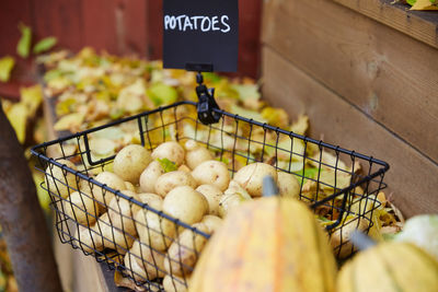 High angle view of raw potatoes in basket at table