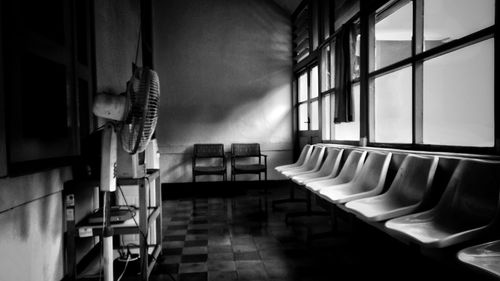 Empty chairs and tables in building