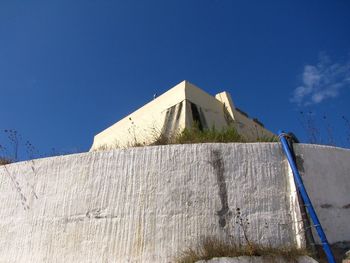 Low angle view of building against blue sky