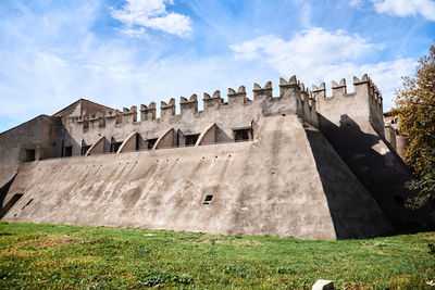 Old ruins on field against sky