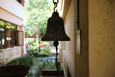 Close-up of lantern hanging on wall