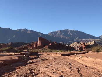 Scenic view of landscape and mountains against clear blue sky