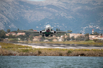 Airplane flying over mountain