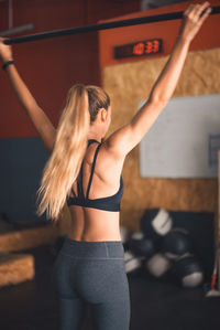 Young woman exercising in gym