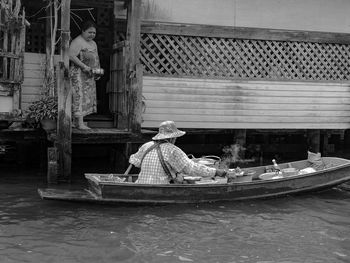 Man working in boat at canal