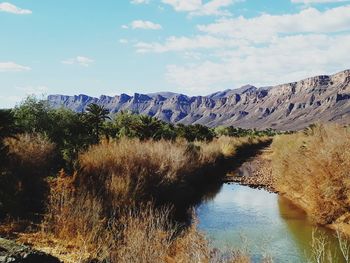 Scenic view of lake and mountains against sky