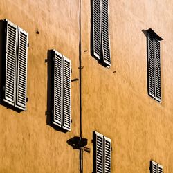 Low angle view of windows on wall of building