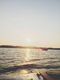 Scenic view of sea against clear sky during sunset