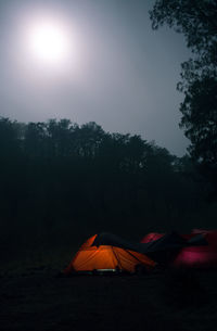 Tent on field against sky at night