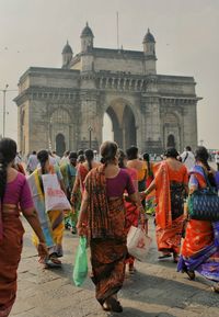 People in front of gateway of india historical building in mumbai. beautiful indian dresses