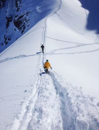 People skiing on snow covered mountain