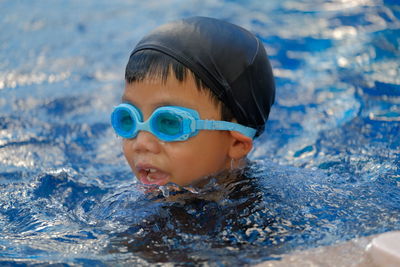 Portrait of boy swimming in pool