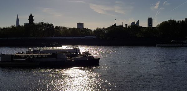 Scenic view of river against sky at sunset