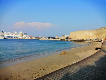 Scenic view of beach against blue sky