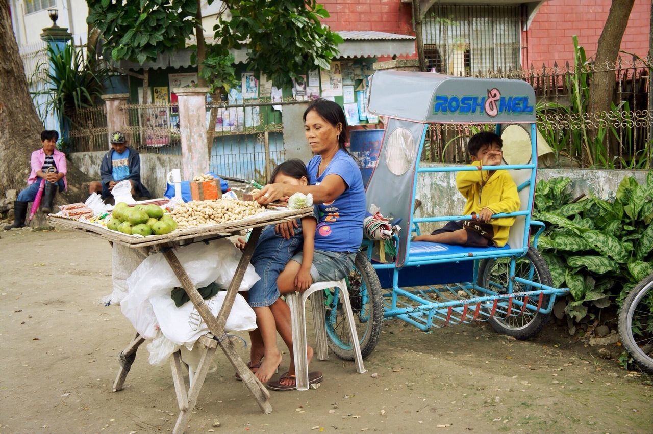 small business, sitting, retail, outdoors, real people, food and drink, day, full length, togetherness, men, friendship, adult, people, food, city, young adult, adults only