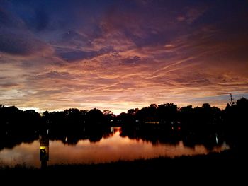 Scenic view of lake against sky at sunset