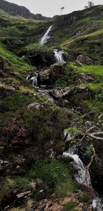 Scenic view of waterfall against sky