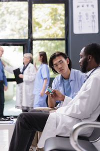 Portrait of doctor examining patient in office