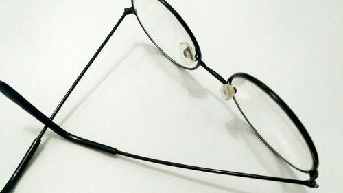 High angle view of eyeglasses against white background