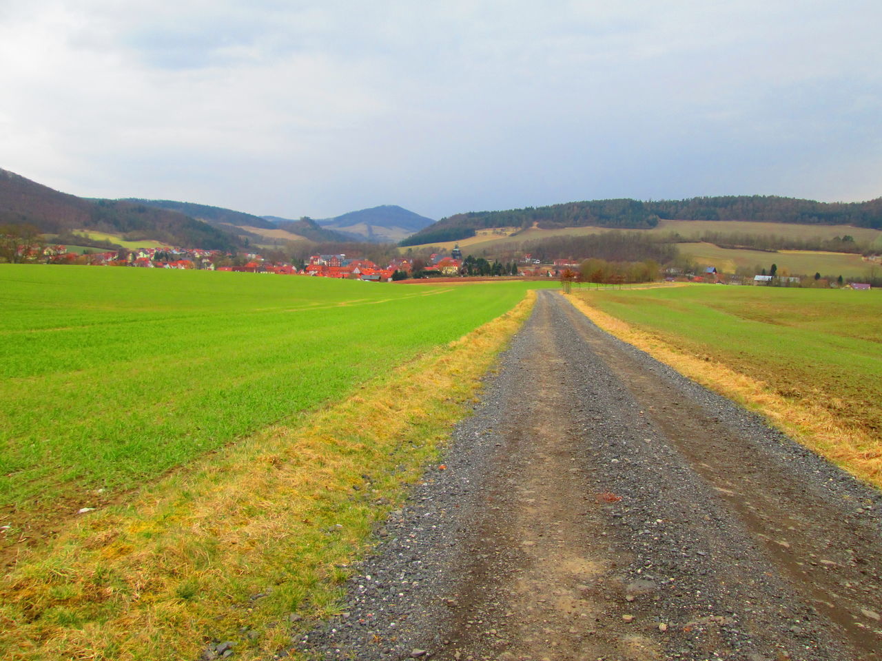 EMPTY ROAD ALONG LANDSCAPE AND MOUNTAINS