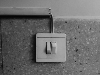 Close-up of light switch mounted on wall