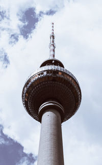 Low angle view of communications tower against sky