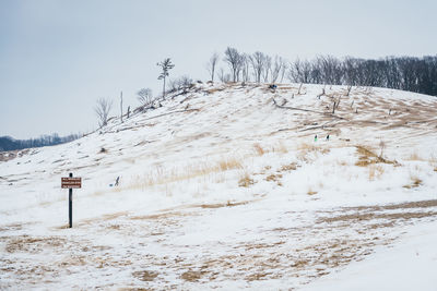 Snow covered land against sky