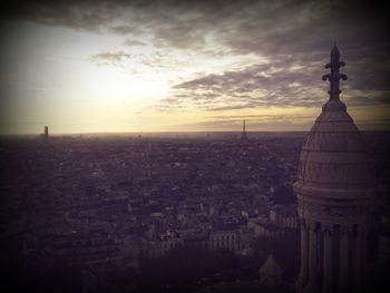 Buildings against cloudy sky at sunset