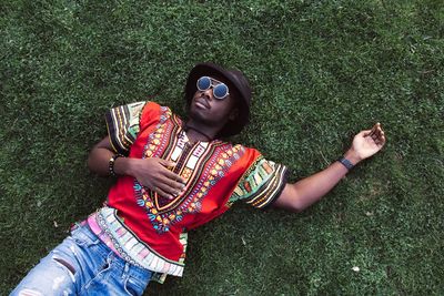 Full length of young woman lying on grass