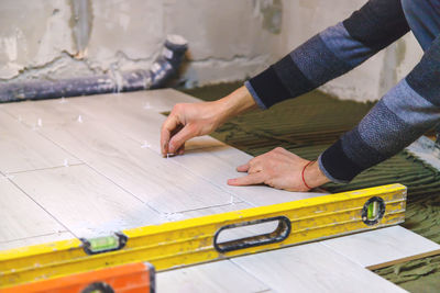 Midsection of man working at workshop